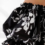 Plus size dress in black floral, lifestyle shot — sharm