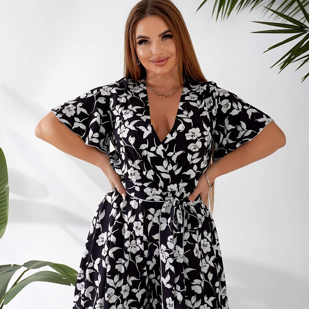 Plus size playsuit in black floral print, front view on model — sharm