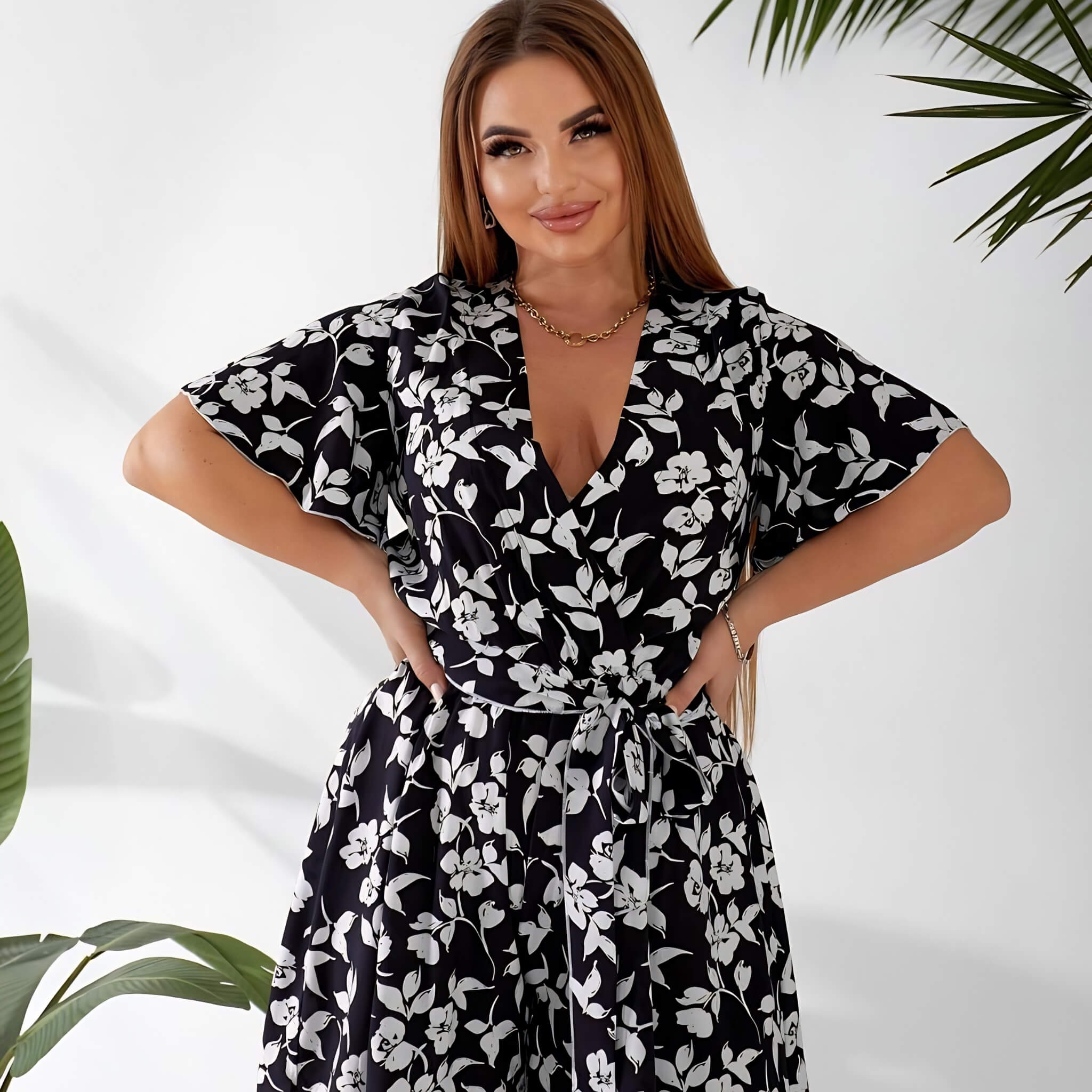 Plus size playsuit in black floral print, front view on model — sharm