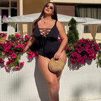 Plus size one-piece swimsuit in black with sun hat, lifestyle shot — sharm