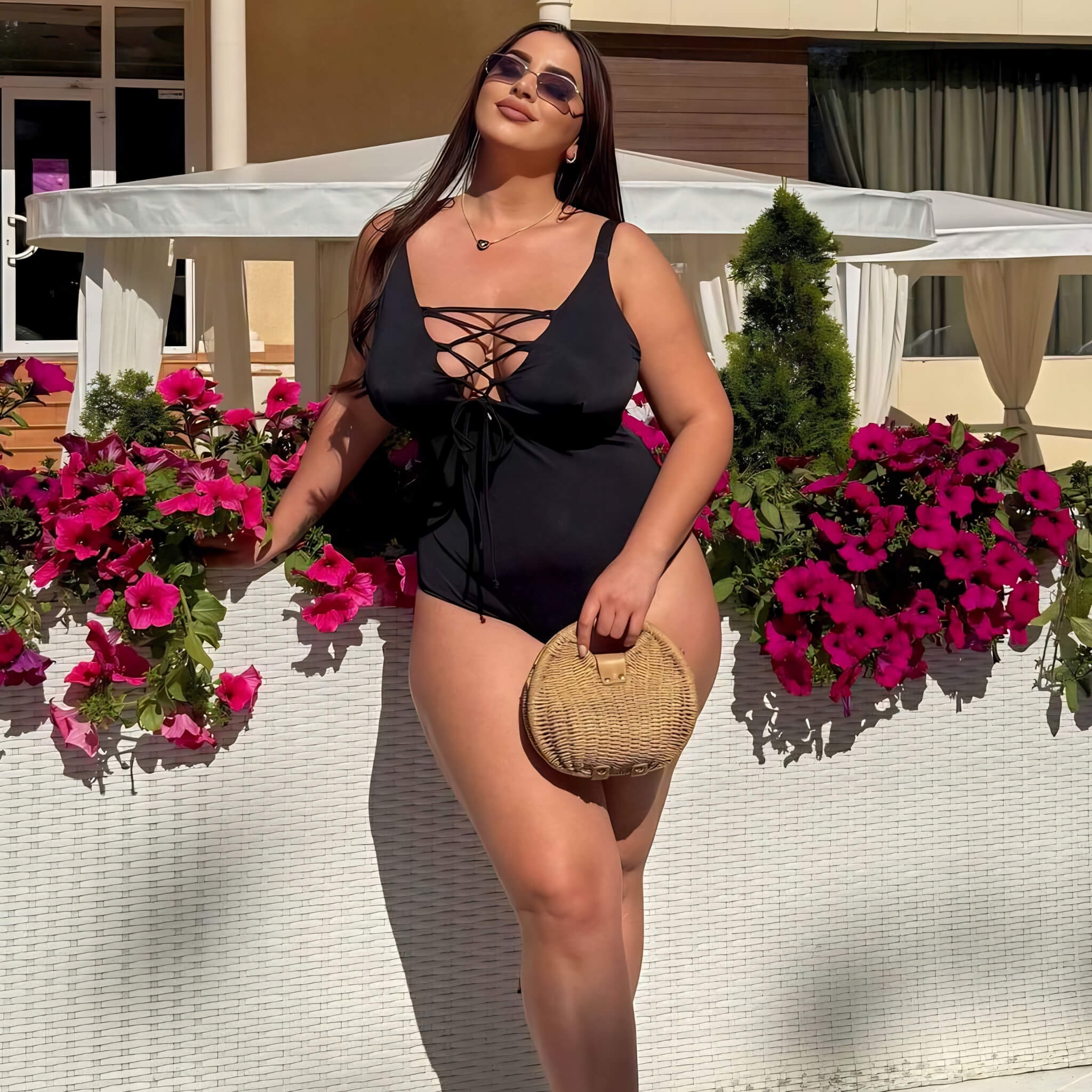 Plus size one-piece swimsuit in black with sun hat, lifestyle shot — sharm