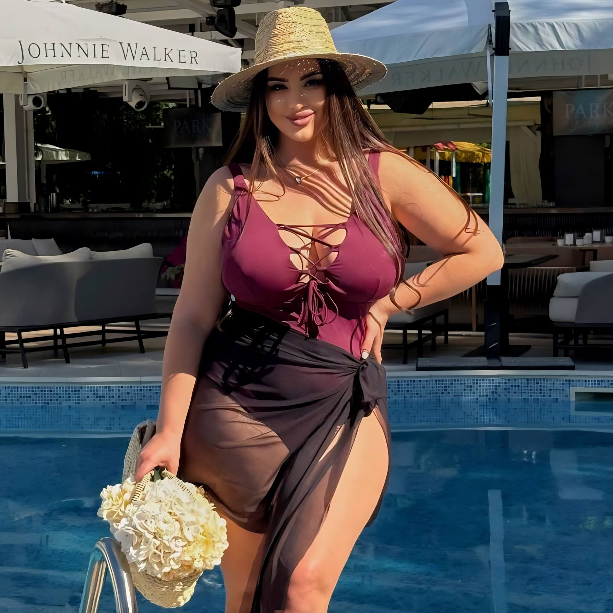 Plus size one-piece swimsuit in black, model with sun hat at pool — sharm